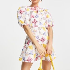 ASOS DESIGN Petite mini skater dress with puff sleeves in pink patchwork floral
